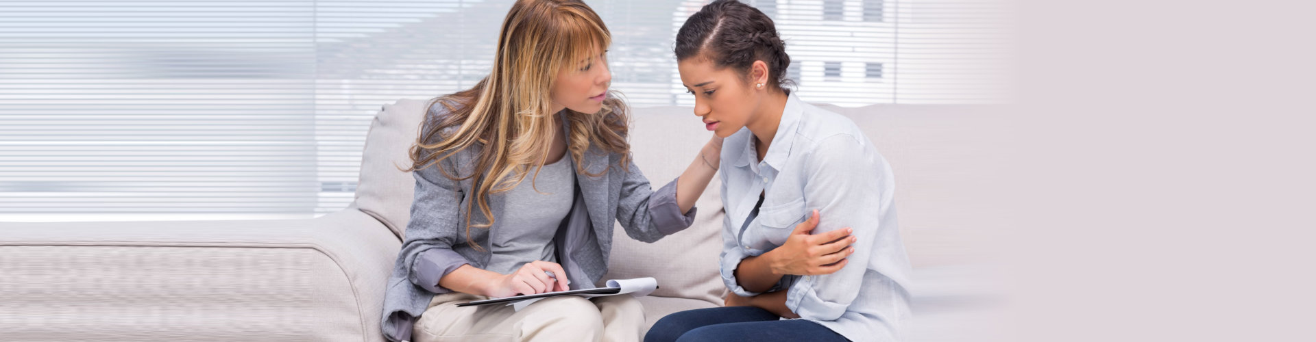 woman with blond hair talking to middle aged woman